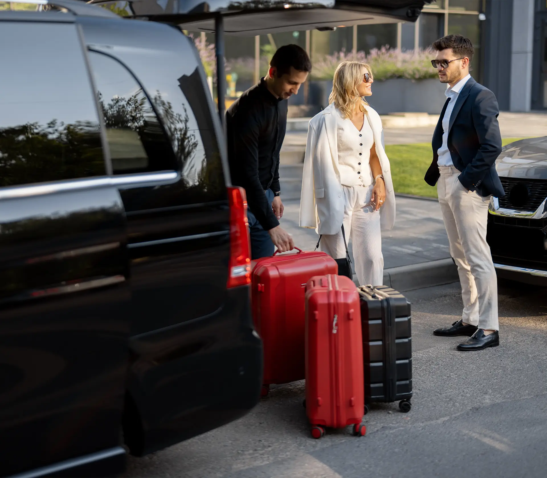 Personen sind am Reiseziel angekommen und Koffer werden aus V-Klasse ggeladen