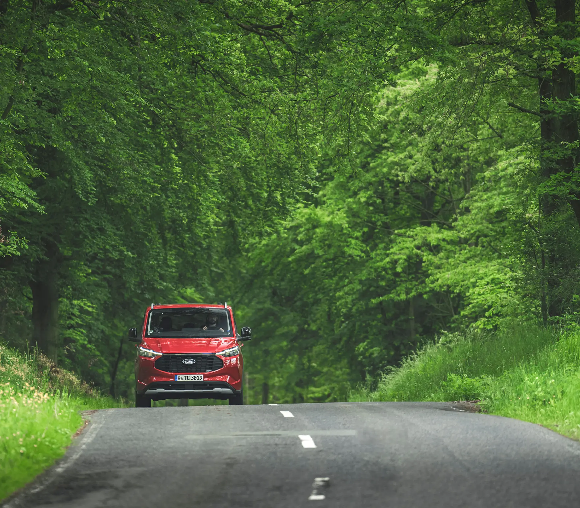 roter Ford Tourneo-Custom fährt auf der Landstraße